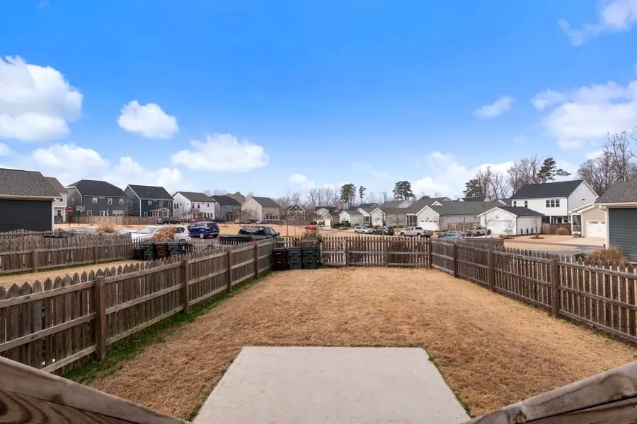 Six-foot dog-ear privacy fence of treated pine in a back yard