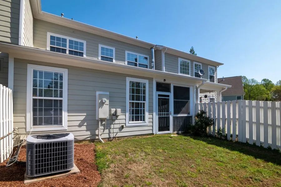 White vinyl privacy fence along a lawn